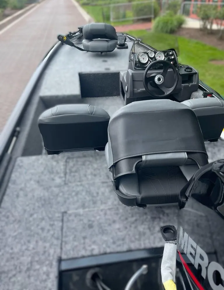 Slide: The Image of 2025 Tracker Pro 170 boat interior with steering wheel and seating. - 2