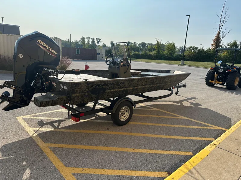 Slide: The Image of 2025 Tracker Grizzly 1860 CC boat on trailer in parking lot. - 4