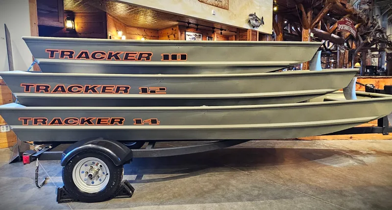 Slide: The Image of 2025 Tracker Grizzly 1236 Utility boats stacked on a trailer in a showroom. - 30