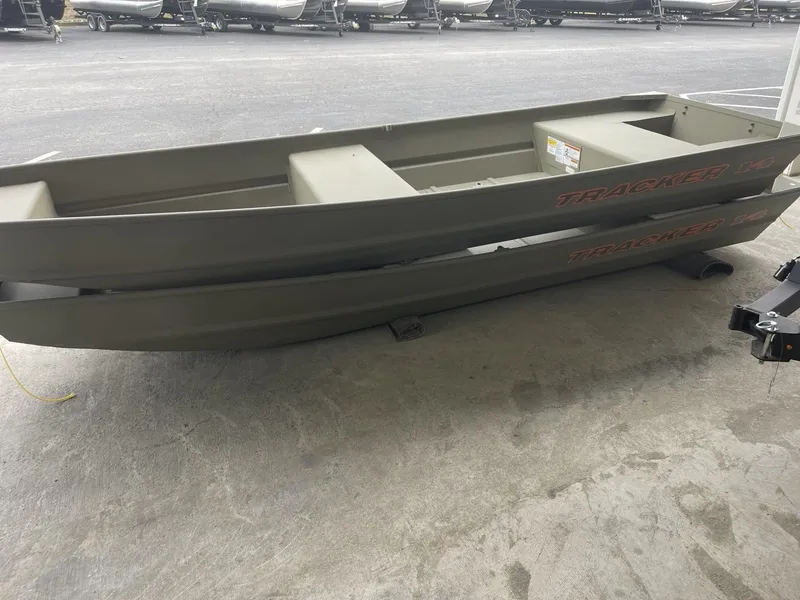 Slide: The Image of 2025 Tracker Grizzly 1436 Utility boat on concrete surface, side view. - 5