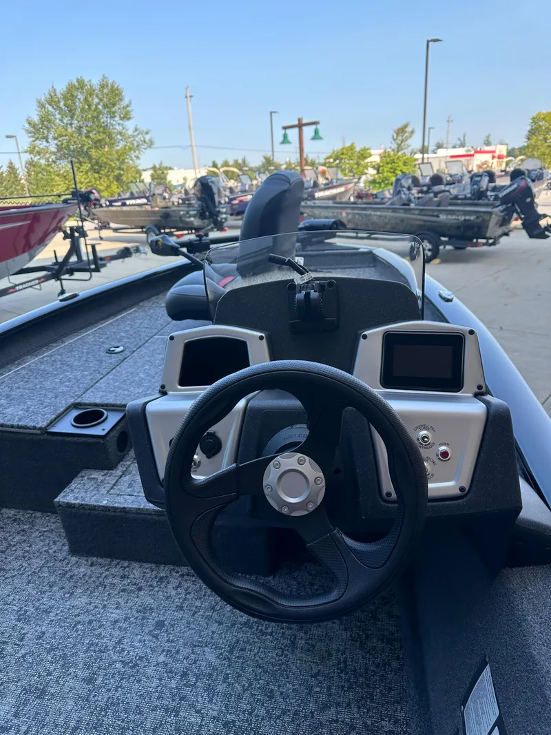 Slide: The Image of 2025 Tracker Pro Team 175 boat dashboard with steering wheel and dual displays. - 3