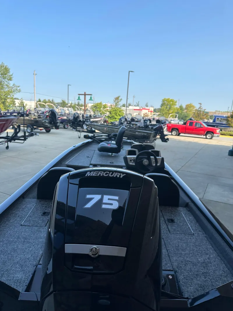 Slide: The Image of 2025 Tracker Pro Team 175 boat with Mercury 75 engine, parked outdoors. - 4