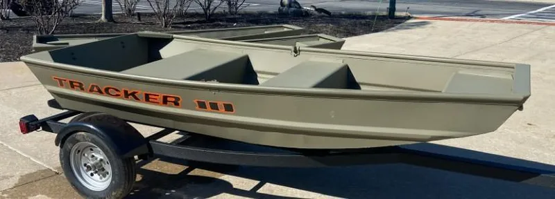 Slide: The Image of 2025 Tracker Grizzly 1036 Utility boat interior, showcasing seating and storage design. - 2