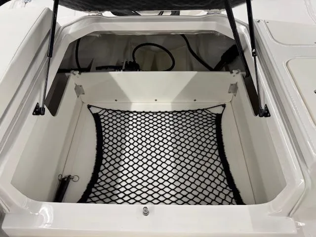 Slide: The Image of 2025 Chaparral 21 SSi Ski & Fish OB storage compartment with netting. - 17