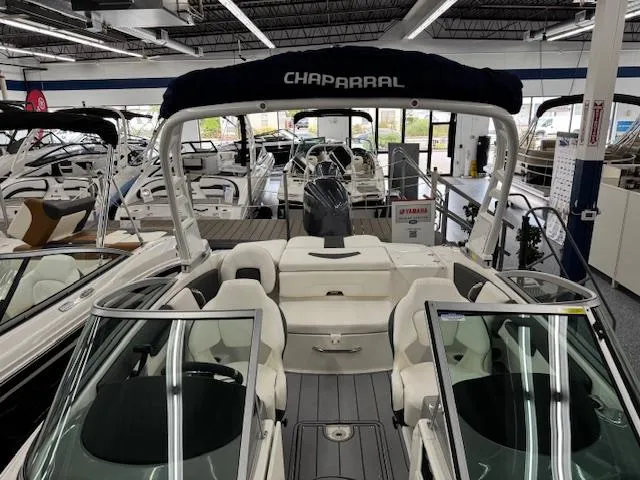 Slide: The Image of 2025 Chaparral 21 SSi Ski & Fish OB boat in showroom, featuring sleek design and spacious seating. - 6