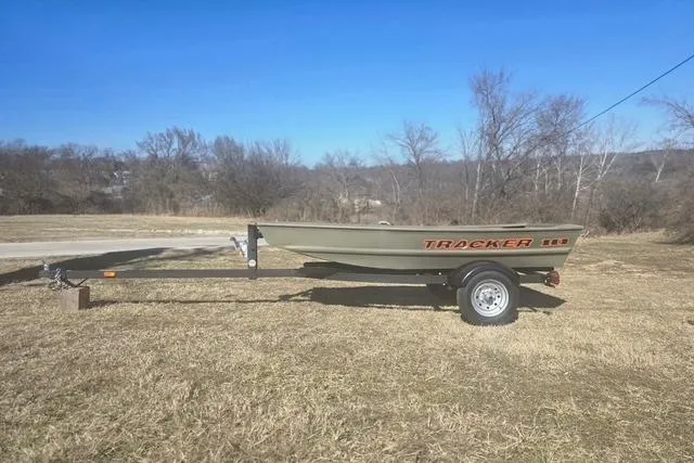 The Image of 2025 Tracker Grizzly 1036 Utility boat on trailer in grassy field. - 0