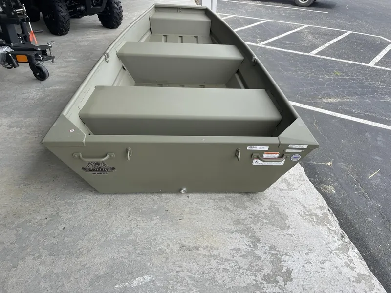 Slide: The Image of 2025 Tracker Grizzly 1236 Utility boat in a parking lot. - 3