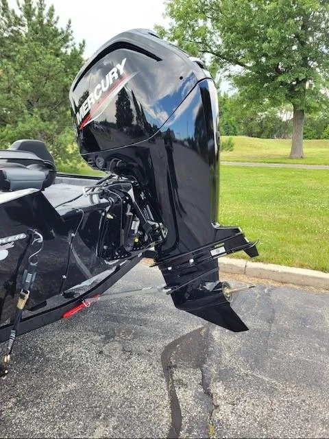 Slide: The Image of 2025 Tracker Pro Team 175 boat with Mercury outboard motor in a park setting. - 2