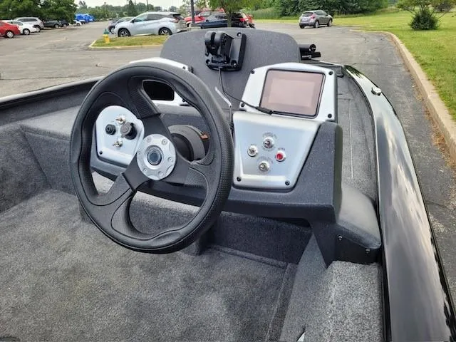 Slide: The Image of 2025 Tracker Pro Team 175 boat dashboard with steering wheel and control panel. - 3