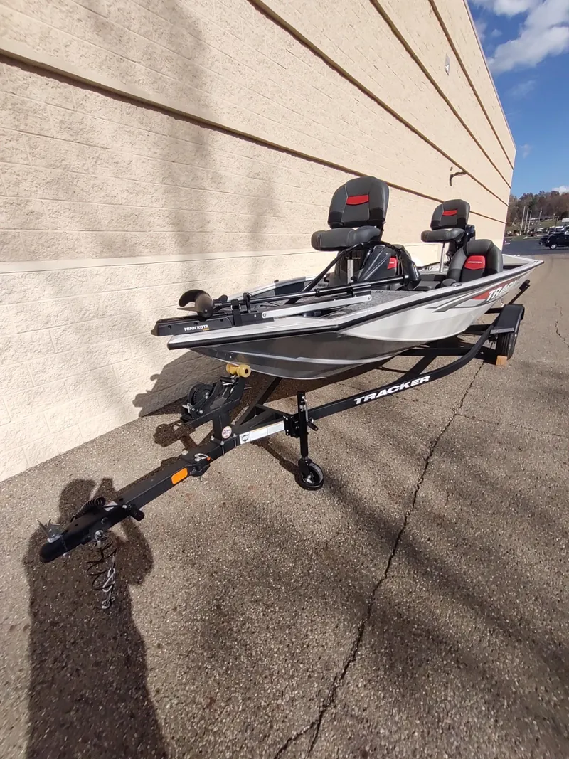 Slide: The Image of 2025 Tracker Pro Team 175 boat on trailer, parked outdoors, sunny day. - 2