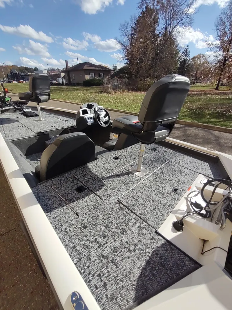 Slide: The Image of 2025 Tracker Pro Team 175 boat interior with seating and steering console. - 5