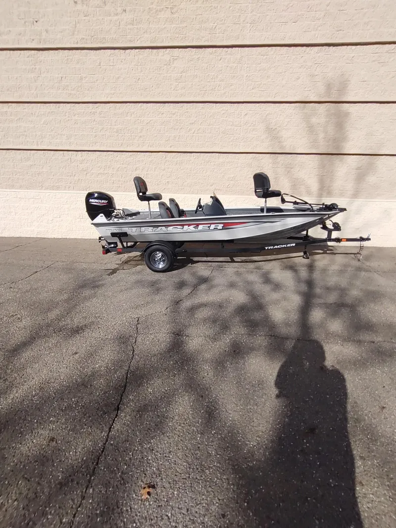 Slide: The Image of 2025 Tracker Pro Team 175 boat on trailer, parked outdoors. - 6