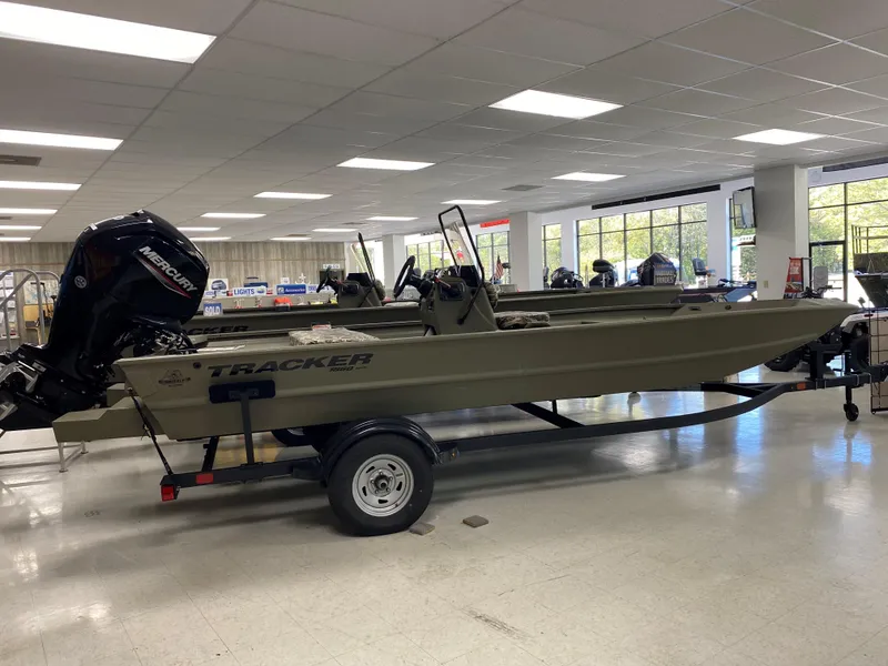 The Image of 2025 Tracker Grizzly 1860 CC boat displayed indoors on a trailer. - 0