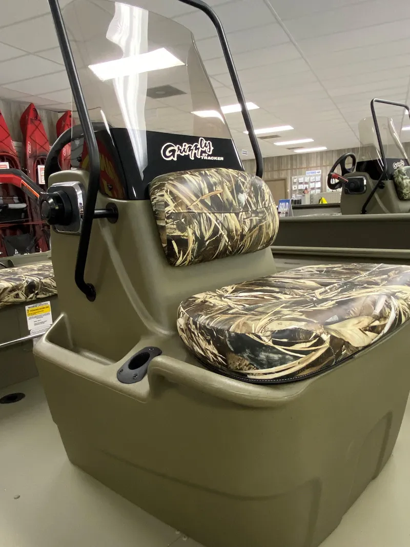 Slide: The Image of 2025 Tracker Grizzly 1860 CC boat seat with camouflage upholstery in showroom. - 2