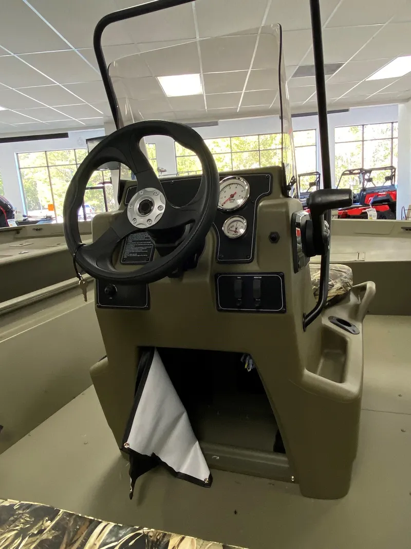 Slide: The Image of 2025 Tracker Grizzly 1860 CC boat console with steering wheel and gauges. - 4