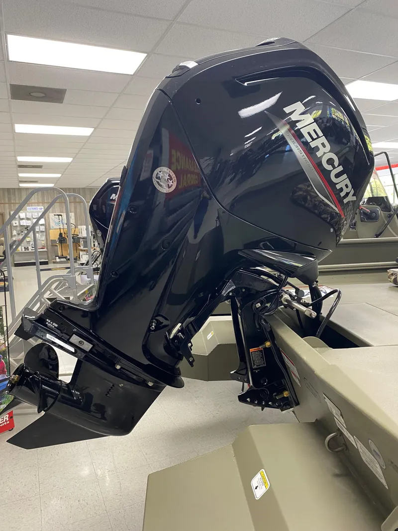 Slide: The Image of 2025 Tracker Grizzly 1860 CC with Mercury outboard motor in showroom. - 5