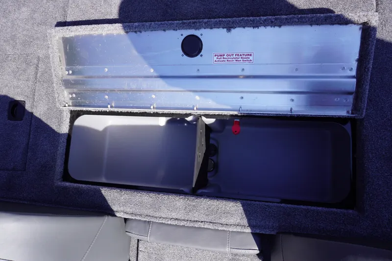 Slide: The Image of Open storage compartment in 2025 Tracker Pro Team 175 boat, featuring pump-out feature. - 6