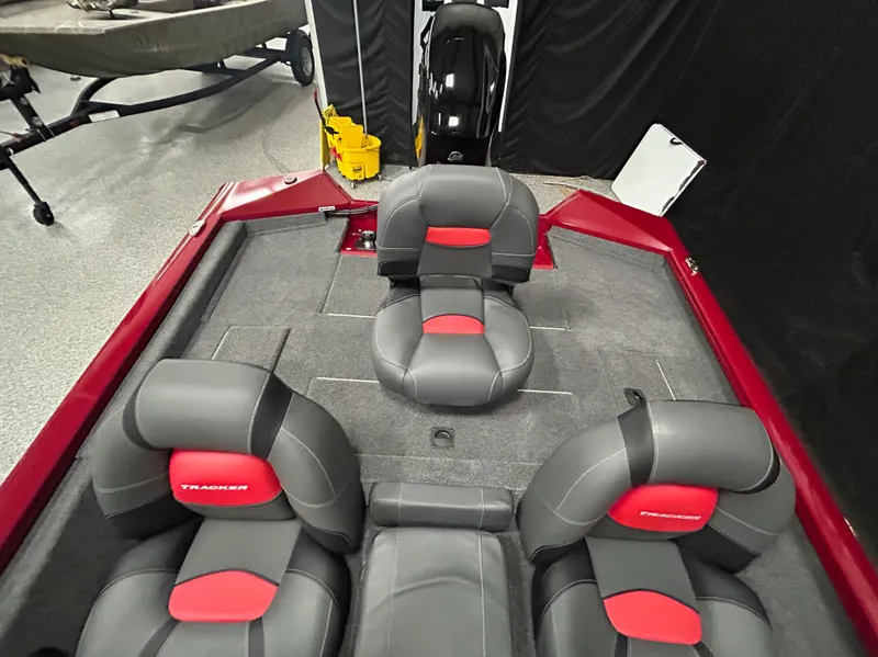 Slide: The Image of 2025 Tracker Pro Team 175 boat interior with gray and red seating. - 10
