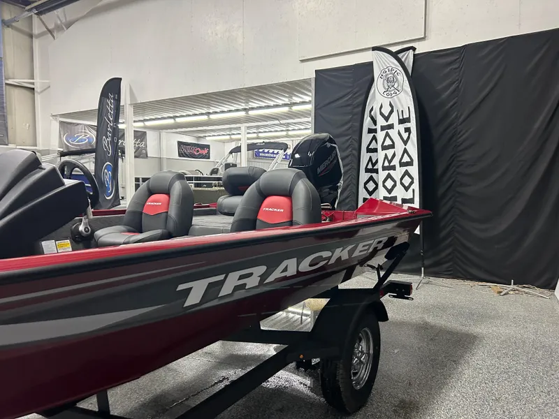 Slide: The Image of 2025 Tracker Pro Team 175 boat displayed indoors with Nordic Lodge banner. - 3