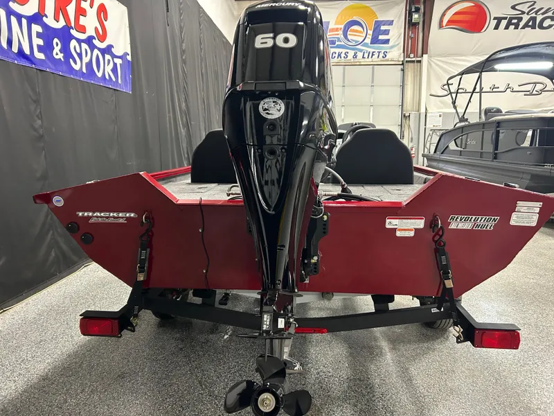 Slide: The Image of 2025 Tracker Pro Team 175 boat with 50 HP engine, displayed indoors. - 4