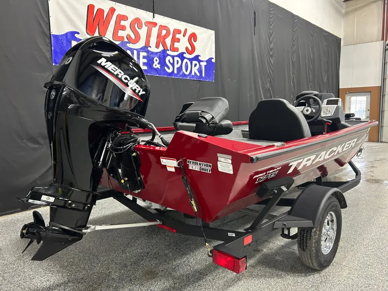 Slide: The Image of 2025 Tracker Pro Team 175 boat with Mercury engine, displayed indoors at Westre's Marine & Sport. - 5