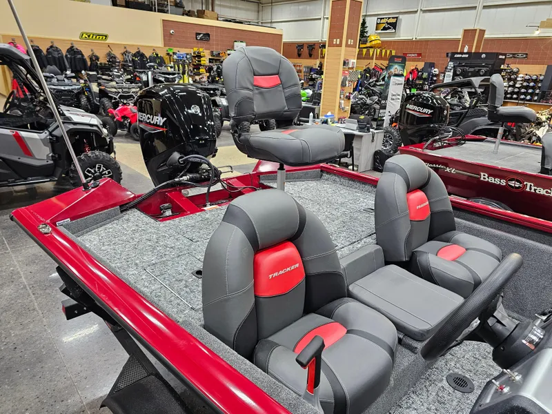 Slide: The Image of 2025 Tracker Pro Team 175 boat with red and gray seating, displayed indoors. - 6