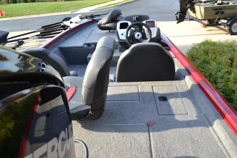 Slide: The Image of 2025 Tracker Pro Team 175 boat interior with seating and steering console. - 2