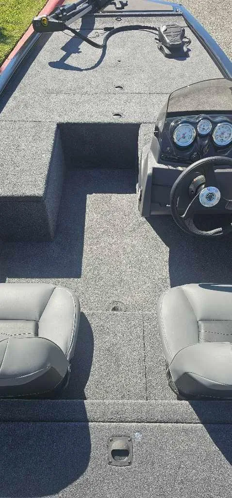 Slide: The Image of 2025 Tracker Pro 170 boat interior with steering console and seating. - 3
