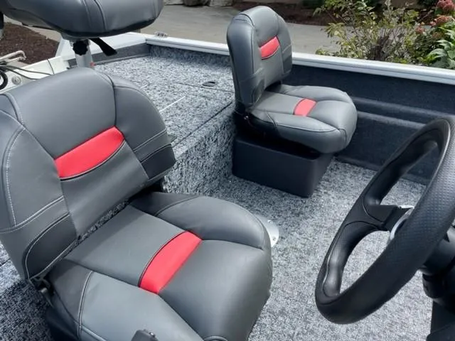 Slide: The Image of 2025 Tracker Pro Team 175 Crappie Edition boat interior with gray and red seats. - 3