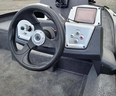 Slide: The Image of 2025 Tracker Pro Team 175 boat dashboard with steering wheel and control panel. - 2