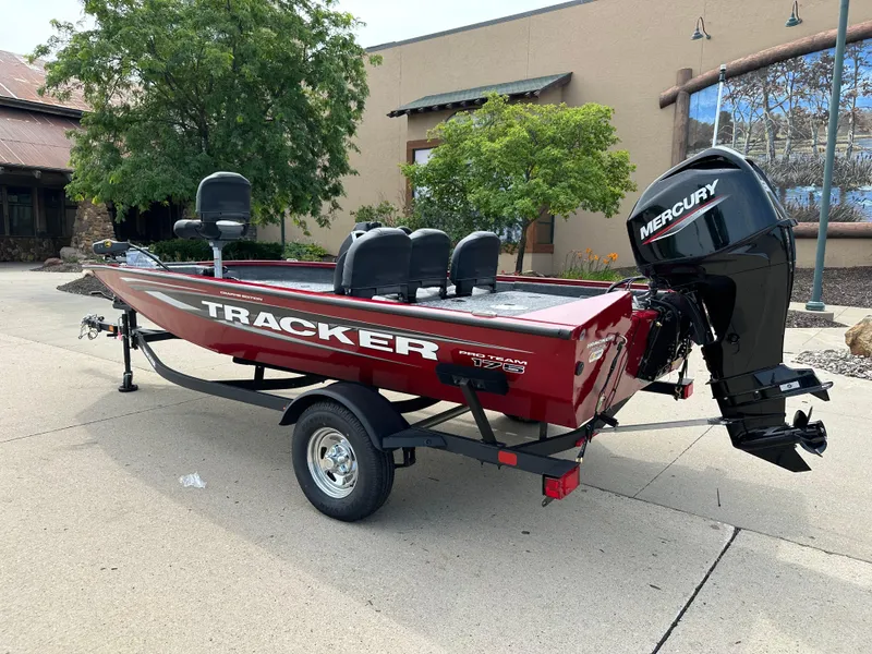 Slide: The Image of 2025 Tracker Pro Team 175 Crappie Edition boat with Mercury engine on trailer. - 2