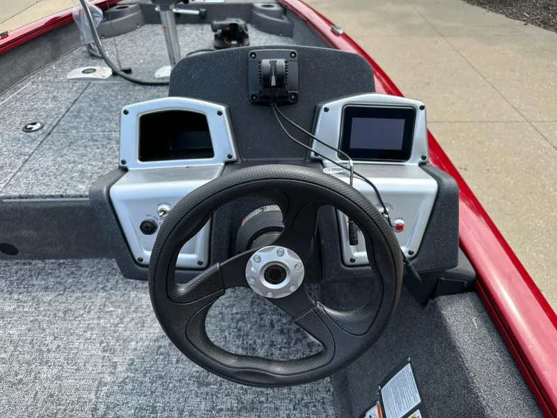 Slide: The Image of 2025 Tracker Pro Team 175 Crappie Edition boat dashboard with steering wheel and dual displays. - 4