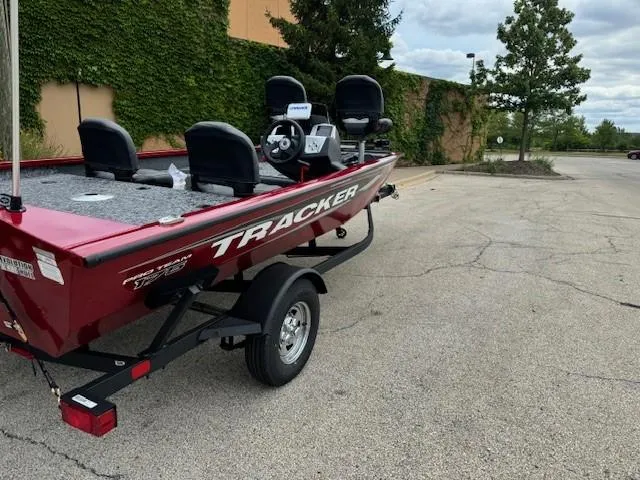 Slide: The Image of 2025 Tracker Pro Team 175 Crappie Edition boat, red, parked outdoors. - 3