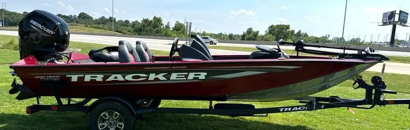Slide: The Image of 2025 Tracker Pro Team 175 boat on trailer, parked on grass. - 4