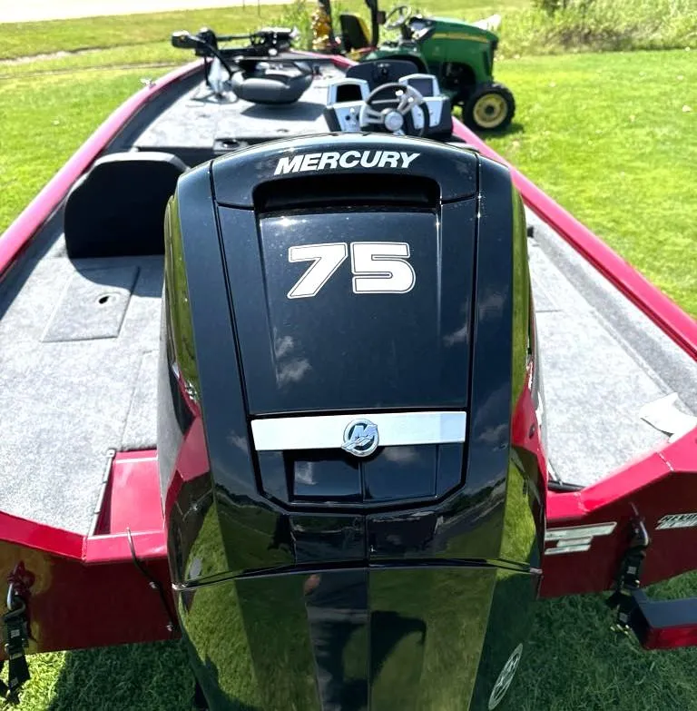 Slide: The Image of 2025 Tracker Pro Team 175 boat with Mercury 75 engine on grass. - 7