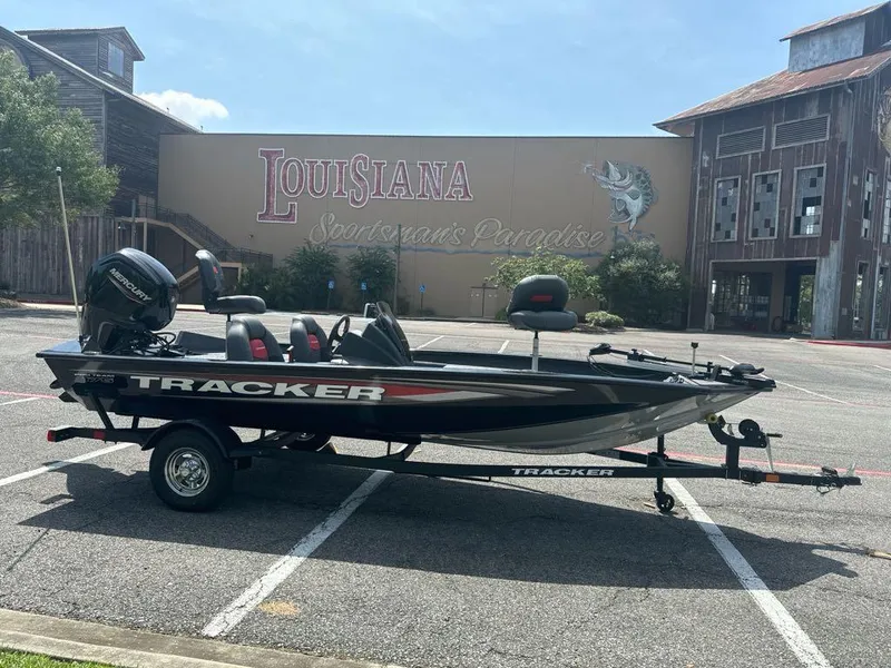 Slide: The Image of 2025 Tracker Pro Team 175 boat parked in front of Louisiana souvenir shop. - 2