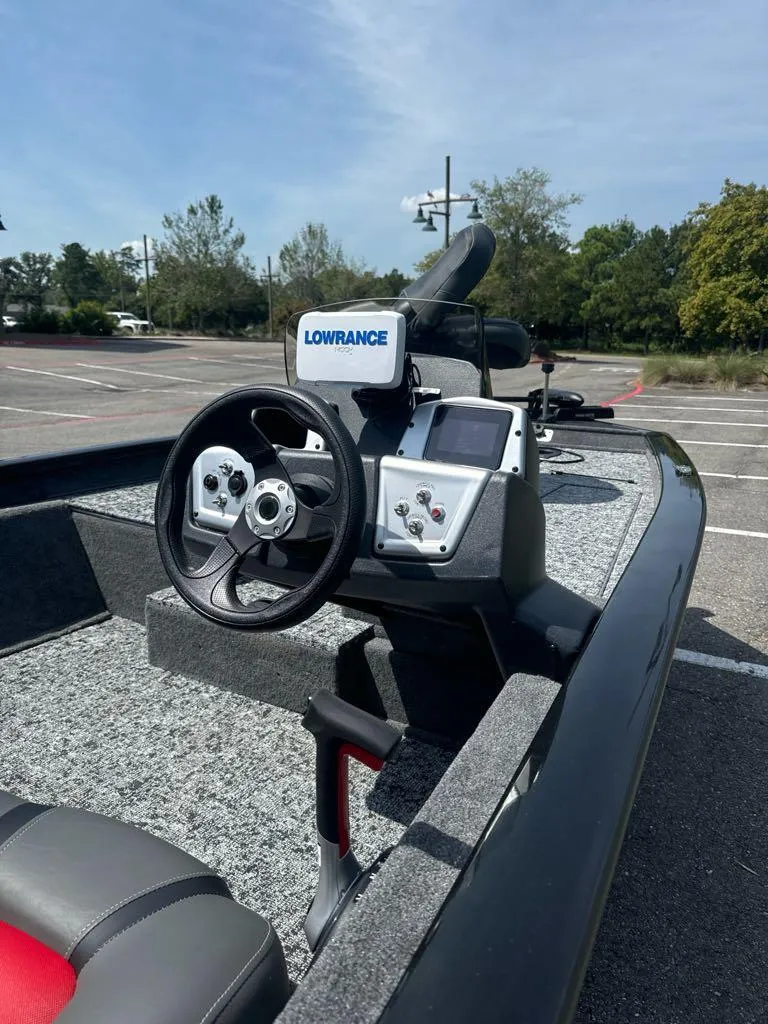 Slide: The Image of 2025 Tracker Pro Team 175 boat with Lowrance navigation system in a parking lot. - 7