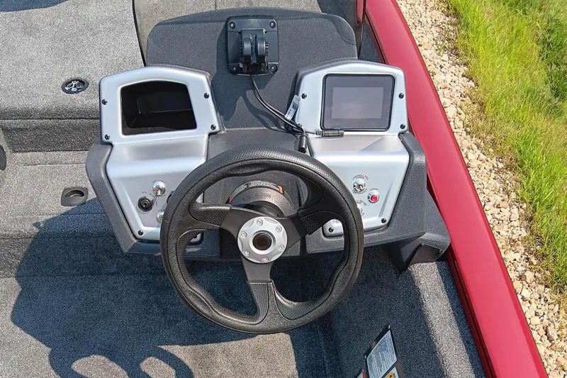 Slide: The Image of 2025 Tracker Pro Team 175 boat dashboard with steering wheel and dual displays. - 4