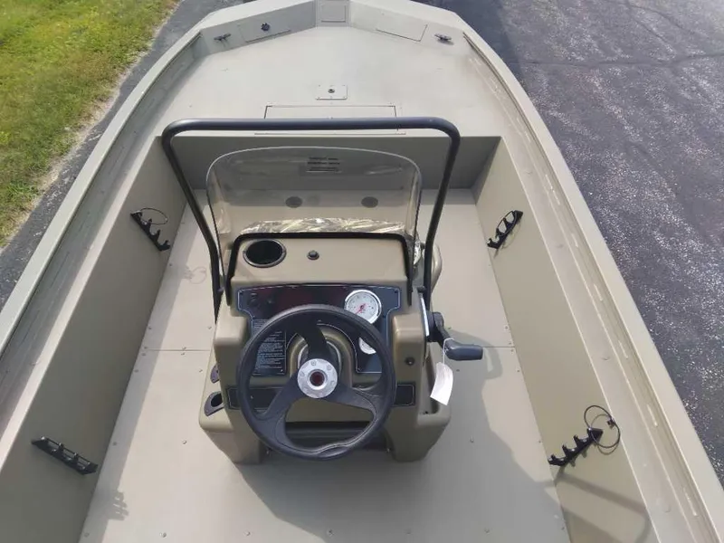 Slide: The Image of 2025 Tracker Grizzly 1860 CC boat interior with steering console and seating. - 2