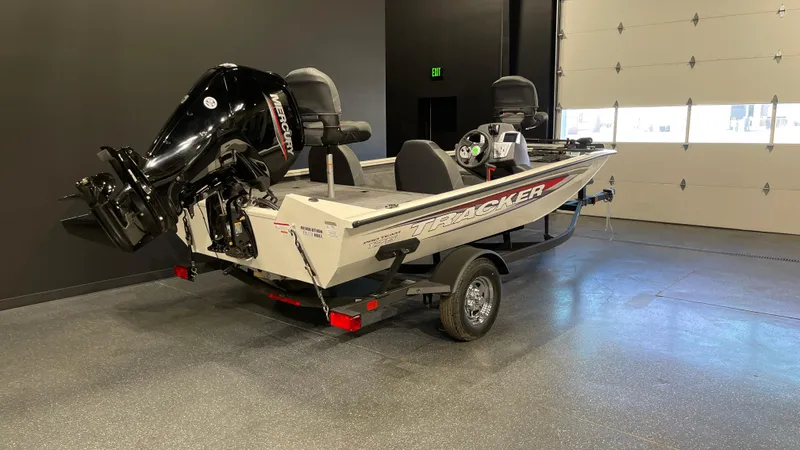 Slide: The Image of 2025 Tracker Pro Team 175 boat in showroom, featuring sleek design and powerful engine. - 3