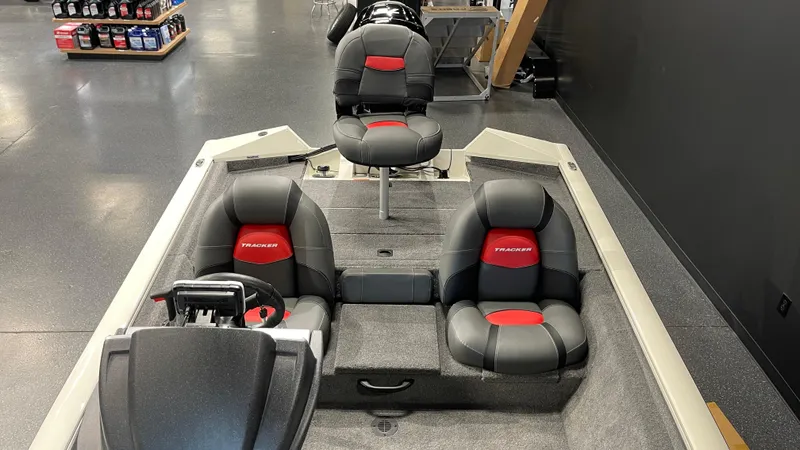 Slide: The Image of 2025 Tracker Pro Team 175 boat interior with three black and red seats. - 8