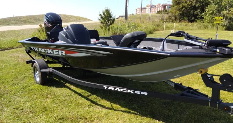 Slide: The Image of 2025 Tracker Pro Team 175 Crappie Edition boat on trailer, parked on grass. - 3