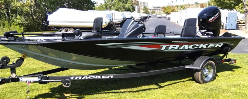 Slide: The Image of 2025 Tracker Pro Team 175 Crappie Edition boat on trailer, parked on grass. - 4
