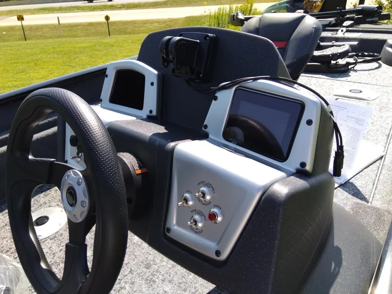 Slide: The Image of 2025 Tracker Pro Team 175 Crappie Edition boat dashboard with steering wheel and controls. - 5