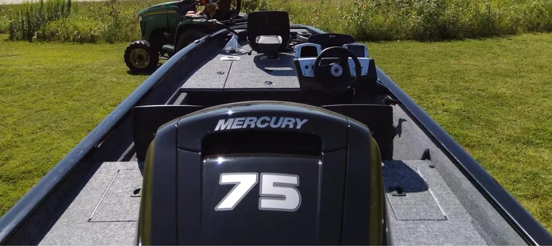 Slide: The Image of 2025 Tracker Pro Team 175 Crappie Edition boat with Mercury 75 engine on grassy field. - 7