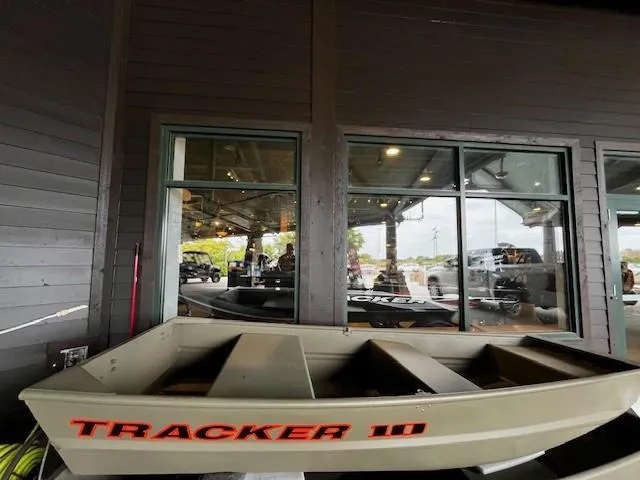 Slide: The Image of 2025 Tracker Grizzly 1036 Utility boat displayed indoors. - 27