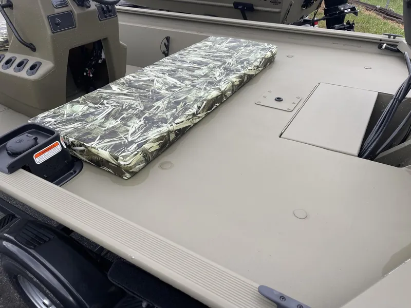 Slide: The Image of 2025 Tracker Grizzly 1860 CC boat interior with camo seat cushion. - 4