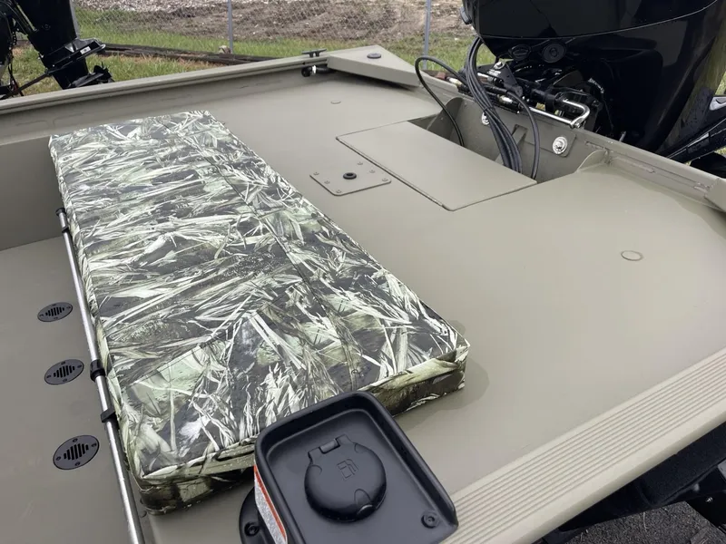 Slide: The Image of 2025 Tracker Grizzly 1860 CC boat interior with camouflage seat and motor. - 5