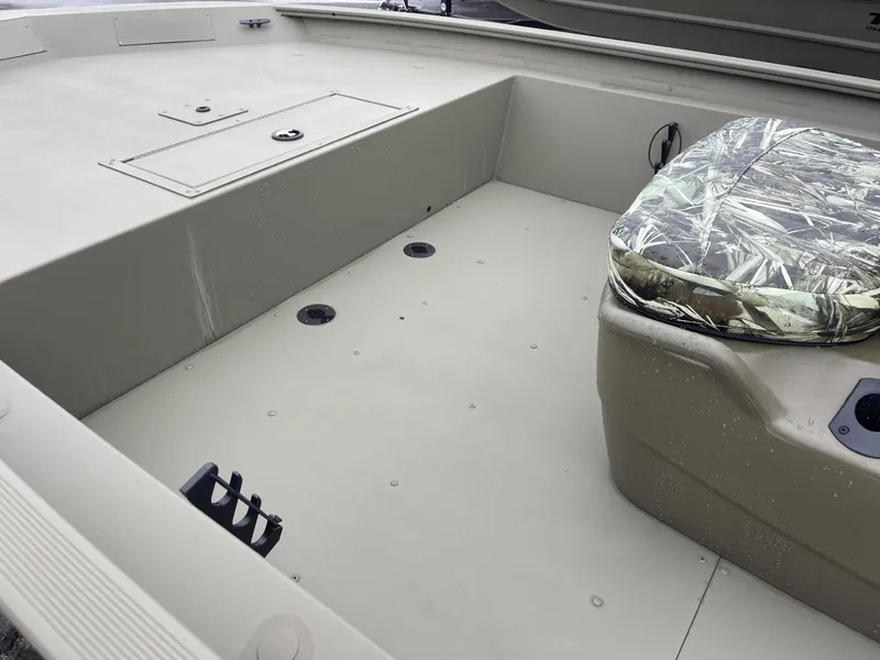 Slide: The Image of 2025 Tracker Grizzly 1860 CC boat interior with camo seat cover. - 8