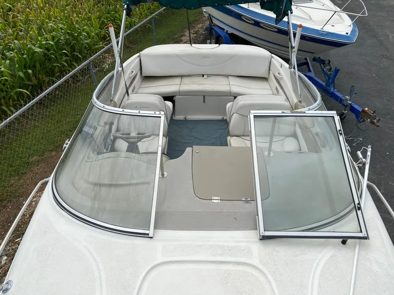 Slide: The Image of 2000 Bayliner 2352 Capri DX/LX boat with open windshield and seating area. - 12